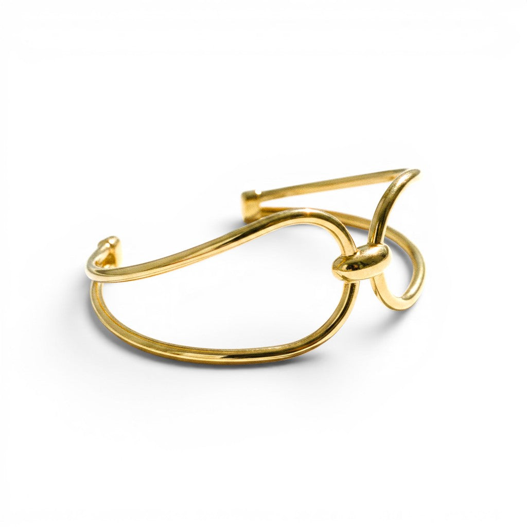 ClaraJoyas gold-plated rigid tubular Italian silver cuff bracelet with a double knot design.