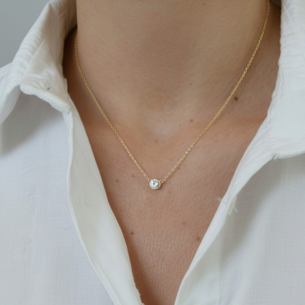 ClaraJoyas gold-plated sterling silver necklace with a bezel-set cubic zirconia pendant on a delicate chain.