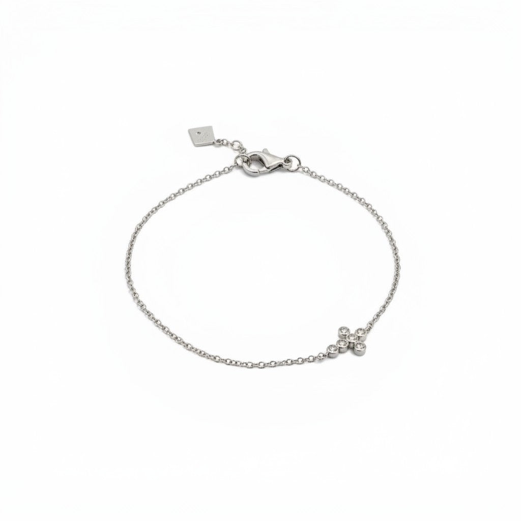 ClaraJoyas sterling silver bracelet with a delicate chain and a small cross pendant adorned with 0.05 ct diamonds.
