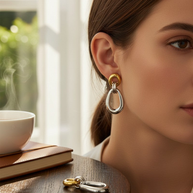 ClaraJoyas two-tone elongated hoop earrings, silver with gold accents, made of rhodium-plated 920 silver.