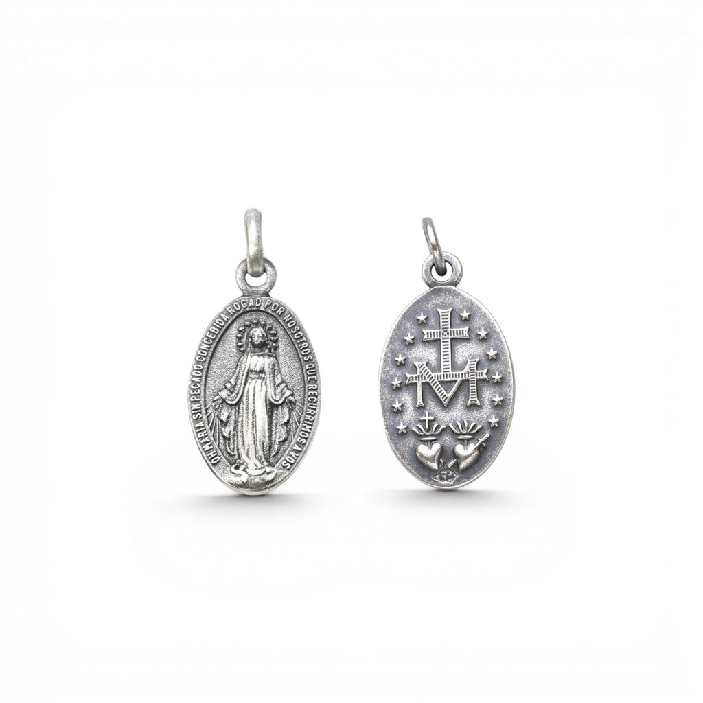Sophia Schneider Joyas oval silver medal featuring Virgin Mary on one side and Sacred Heart with M emblem on the other.