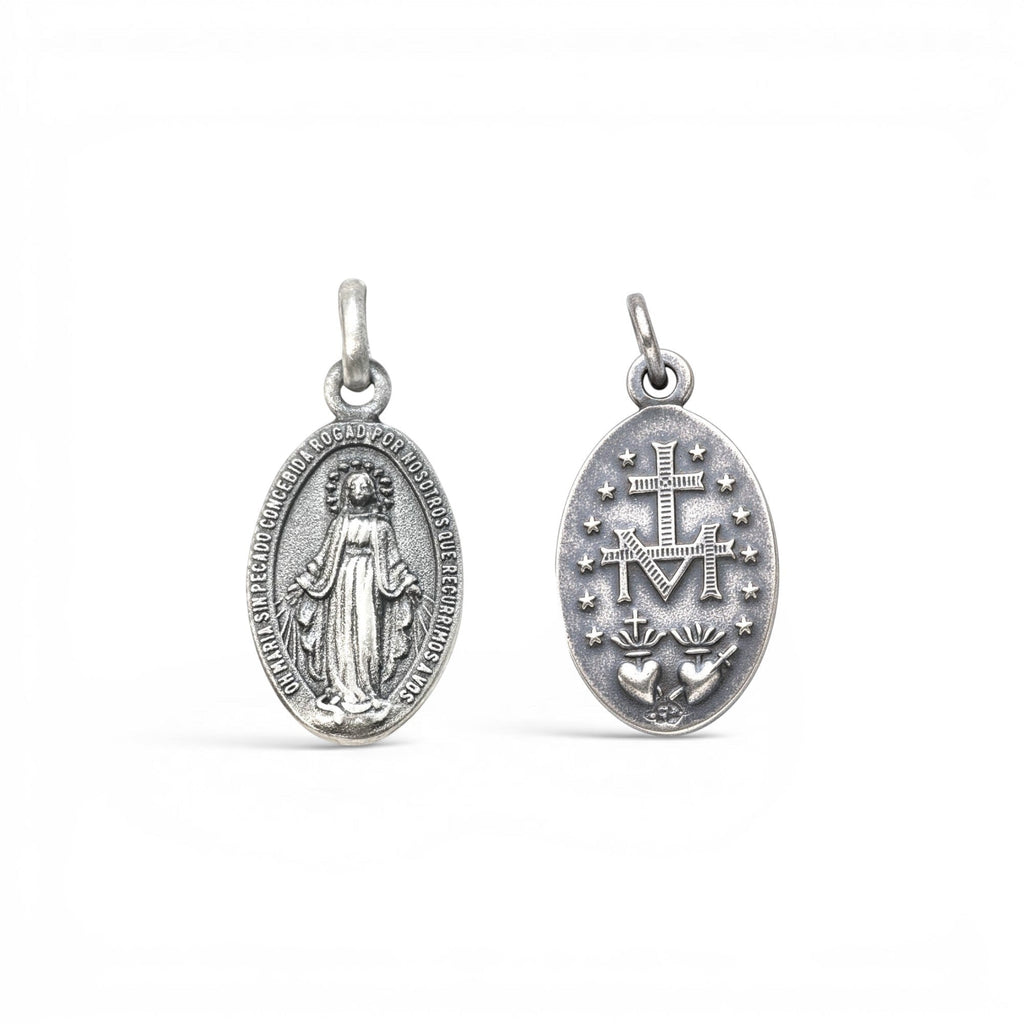 Sophia Schneider Joyas oval silver medal featuring Virgin Mary on one side and Sacred Heart with M emblem on the other.