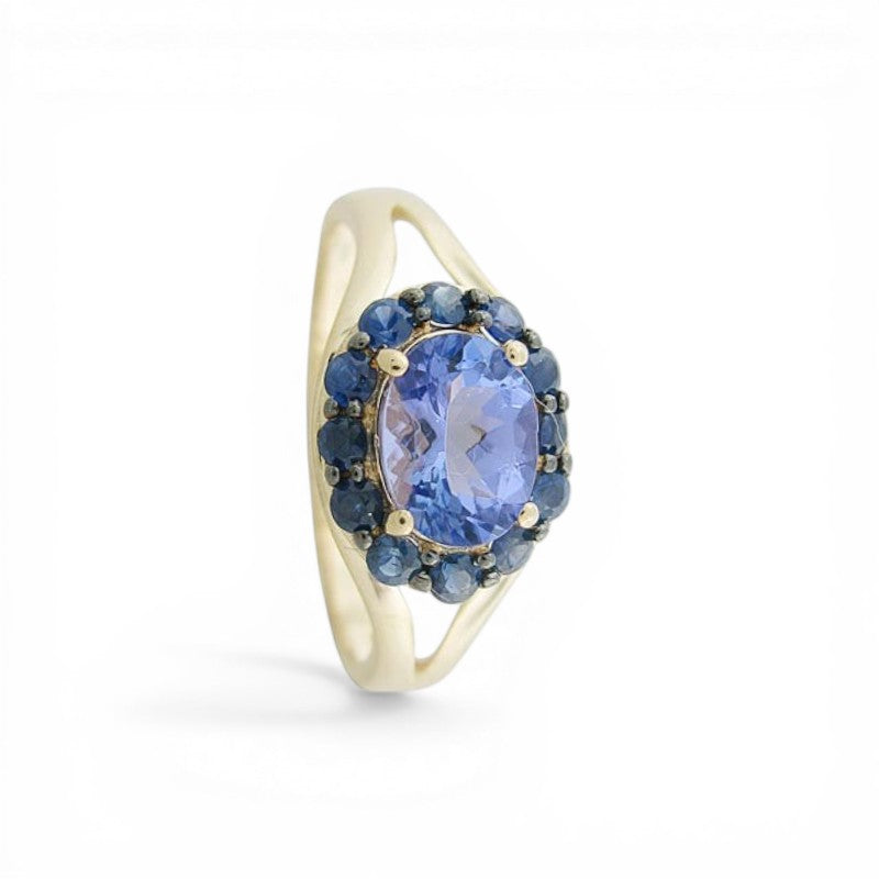 Sophia Schneider Joyas oval tanzanite ring with sapphire halo in silver. 1.82 ct tanzanite, 2.06 ctw sapphires.