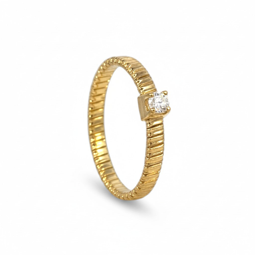 Sophia Schneider Joyas gold-plated silver ring with diamond accent and textured band.