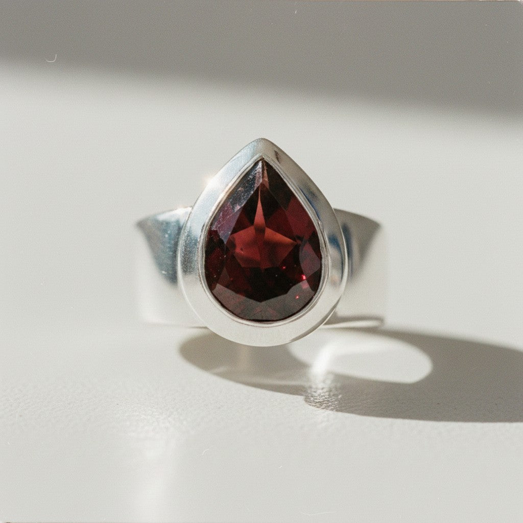 Sophia Schneider Joyas silver ring with a 6.53 ct pear-cut garnet gemstone.