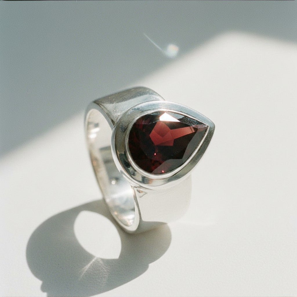 Sophia Schneider Joyas silver ring with a 6.53 ct pear-cut garnet gemstone.